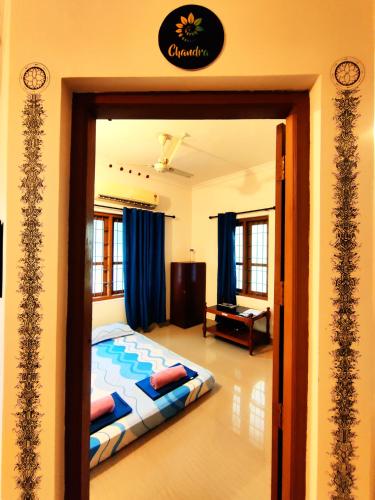 a bedroom with a bed in a room at Jambavan Arts Sanctuary in Varkala