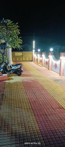 a motorcycle parked in a parking lot at night at Humdum Holiday Homes 1 in Neral