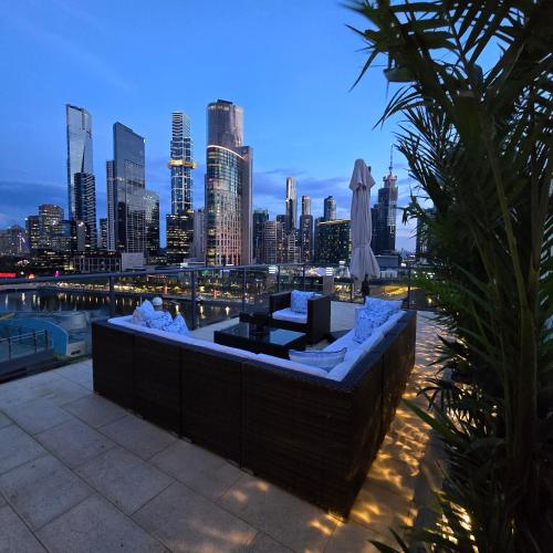 a rooftop bar with a view of a city skyline at Pristine on Flinders in Melbourne