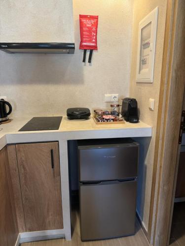 a kitchen with a counter with a sink and a dishwasher at Aristi boutique stonehouse with attic in Aristi