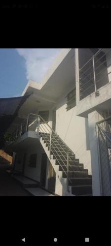 a building with a staircase in front of a building at Hotel la Bastilla in Sincelejo