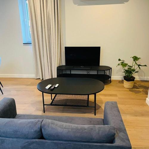 a living room with a couch and a coffee table at Tante Ursula B&B in Venlo