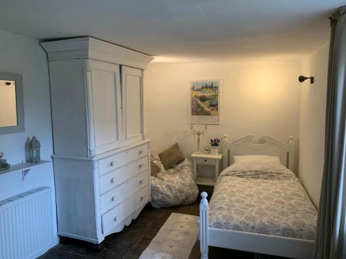 a bedroom with a bed and a large dresser at 5Arsouze in Châtelus-le-Marcheix