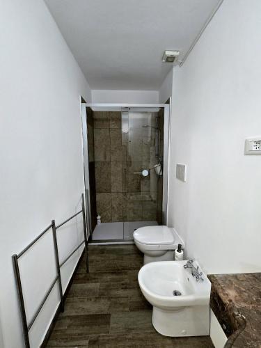 a bathroom with a toilet and a sink and a shower at La Casina in Follonica
