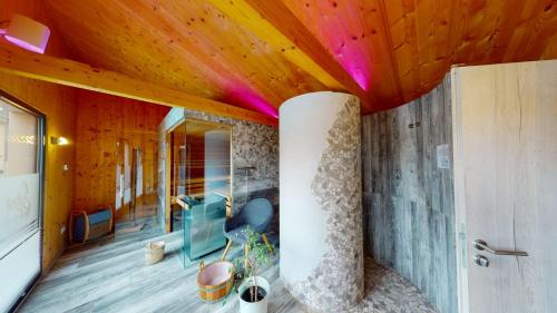 a living room with a wooden ceiling and a room at FBA Village in Bundenthal