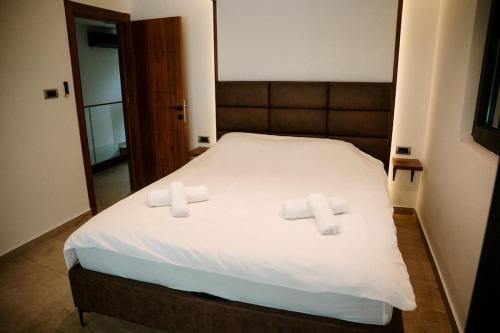 a bedroom with a bed with two crosses on it at Riverhouse PIER in Beograd