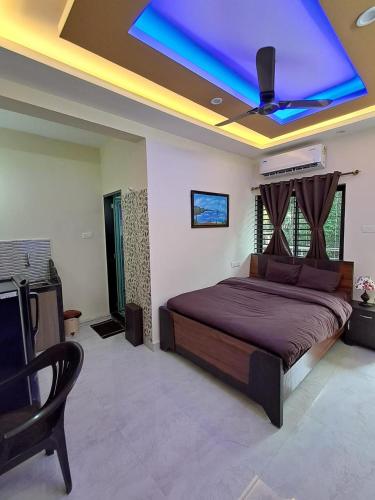 a bedroom with a large bed with a purple ceiling at Whispering Waves Luxury Homes in Majorda