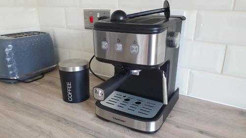 a coffee maker sitting on top of a counter at Lovely 3 Bedroom House Manchester in Manchester