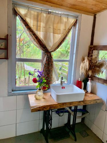 a bathroom with a sink and a window at Romantic house 2 on a pine hill Dalat in Da Lat