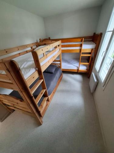 une chambre avec deux lits superposés et une fenêtre dans l'établissement La parée, piscine, proche mer et centre ville, à Bretignolles-sur-Mer