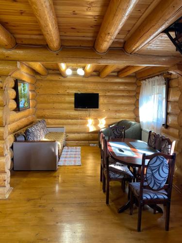 a living room with a table and a couch at Smerekovyi Dvir in Polyana