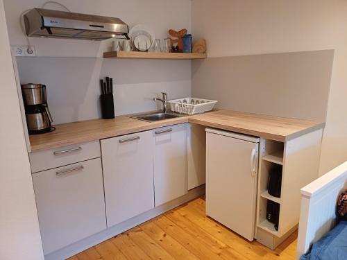 a small kitchen with white cabinets and a sink at Schönes Einzelzimmer in Nähe zur Wutachschlucht in Löffingen
