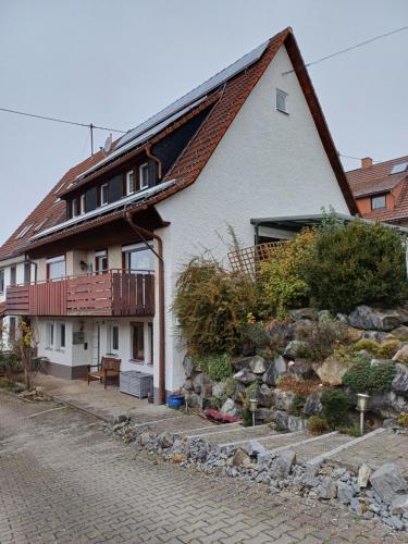 a white house with a balcony on the side of it at Schönes Einzelzimmer in Nähe zur Wutachschlucht in Löffingen
