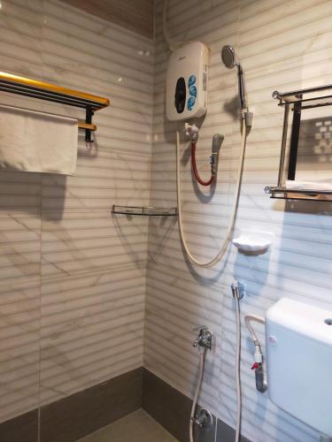 a shower in a bathroom with a glass door at HOTEL SRI IMPIAN in Johor Bahru