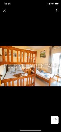 a bedroom with two bunk beds and a window at Villa 4 in Ayia Thekla in Ayia Napa