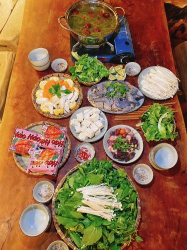 a table with many plates of food on it at Khói Panorama in Dồng Văn