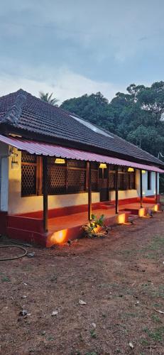 a building with a roof with lights on it at Taramrata Homestay in Gokarna