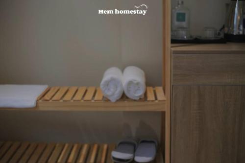 a closet with wooden shelves with white towels at Hẹ Stay in Hue