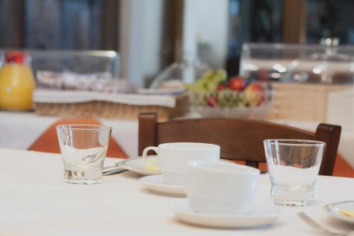 a table with plates and glasses on top of it at Agriturismo Ai Prati in Perugia