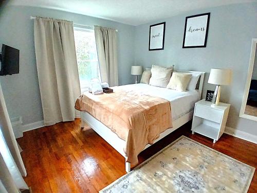 a bedroom with a large bed and a window at Luxury & Restful Private Room in DC in Washington, D.C.