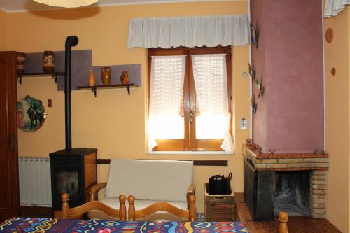 a living room with a bed and a fireplace at Villa Maria - Sant'Angelo di Brolo in SantʼAngelo di Brolo