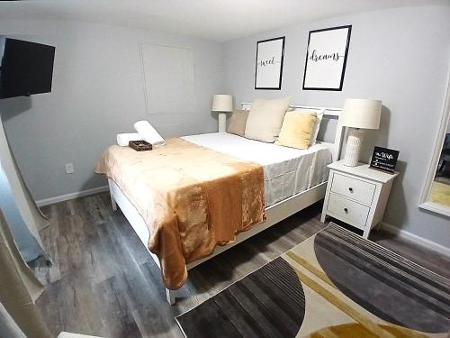 a bedroom with a bed with two lamps on it at Luxury & Mellow Private Room in DC in Washington, D.C.