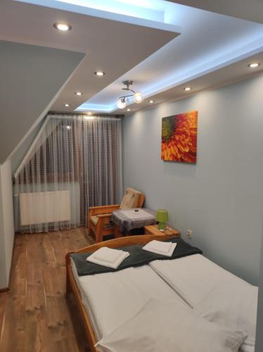 a bedroom with a bed and a couch and a staircase at Willa Ewa in Poronin