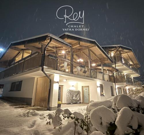 a building covered in snow at night at REY Chalet in Vatra Dornei