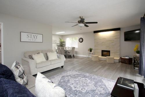 a living room with a couch and a fireplace at Entire Magill House by RiverPark in Fresno