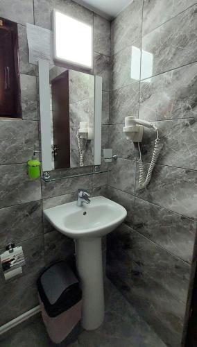 a bathroom with a sink and a mirror at Cabana Dochita 2 in Ceahlău