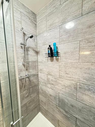 a bathroom with a shower with a glass door at Southall Edge Inn in Southall