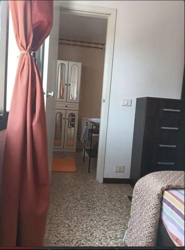 a room with a bed and a dresser and a curtain at Magic view facing MontanaRoja in La Tejita