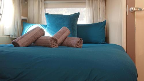 a blue bed with two towels on top of it at Skye-Fall in Drumfearn
