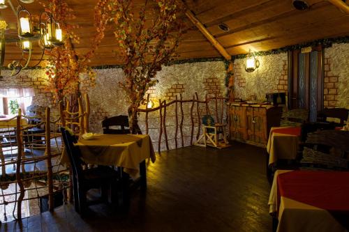 a restaurant with tables and chairs in a room at Recreation Complex Uzhanski Kupeli in Volosyanka