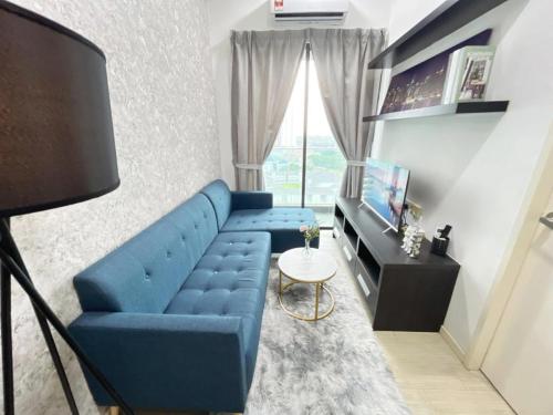 a living room with a blue couch and a television at PJ 2 Room ID home design 1-8 pax 5 min to One U in Petaling Jaya