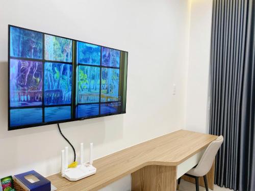 a flat screen tv hanging on a wall at DOME APARTMENT in Nhơn Trạch