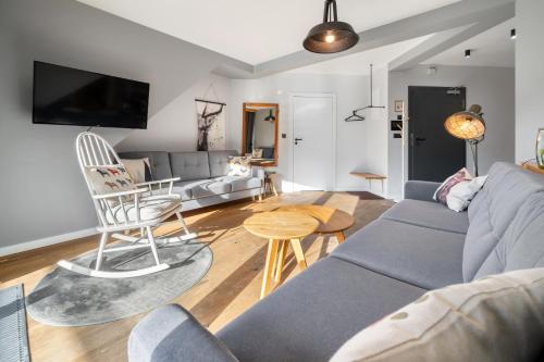 a living room with a couch and a table at Green Deer Premium in Zakopane