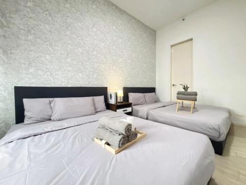 a bedroom with two beds with a tray on it at PJ 2 Room ID home design 1-8 pax 5 min to One U in Petaling Jaya