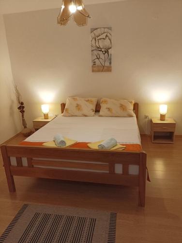 a bedroom with a bed with two towels on it at Apartment Dunja in Senj