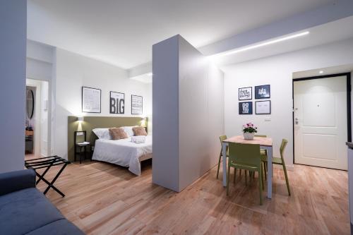 a living room with a bed and a table at Love Suite Verona in Verona