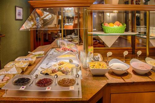 a buffet with many different types of food on a counter at Hotel Fürsteneck in Bernburg