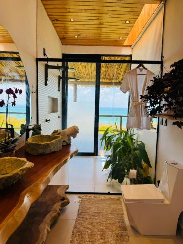 a room with a counter with a dress on a rack at Casa Amar Pipa in Pipa