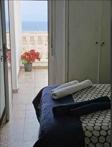 a bedroom with a bed with a view of a balcony at Magic view facing MontanaRoja in La Tejita