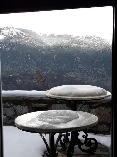 a table with a pillow on top of a snow covered mountain at Winter Breeze in Arachova