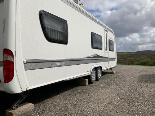 a white trailer parked on the side of a road at Skye-Fall in Drumfearn