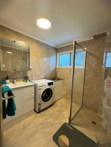 a bathroom with a washing machine and a sink at Heaven on Earth in Kingston