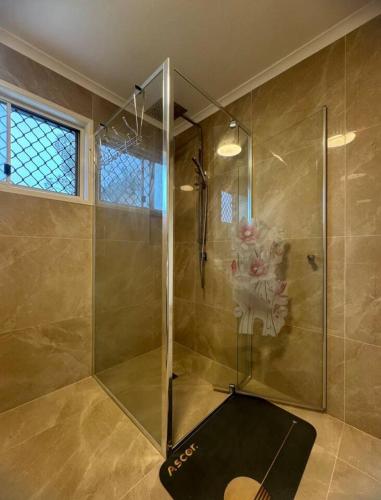 a shower with a glass door in a bathroom at Heaven on Earth in Kingston