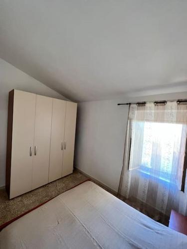 a room with a bed and a window at Lupo di Mare in Cuglieri
