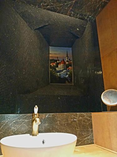 a bathroom with a bath tub with a picture on the wall at Parlament in Tallinn