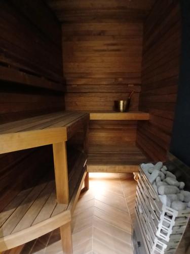 a sauna with wooden walls and a wooden table at Parlament in Tallinn